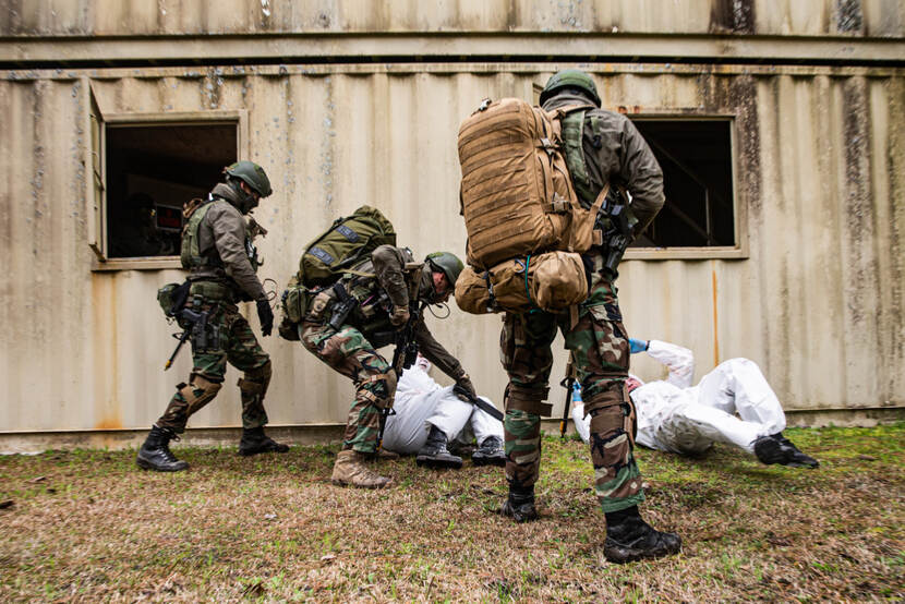 3 marines are holding 2 'suspects' at gunpoint during the exercise at Camp Lejeube.