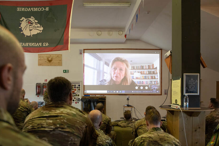 Dutch military personnel in Lithuania listen closely to Ollongren.