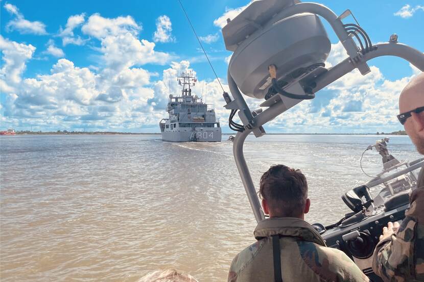 Military personel on a boat.