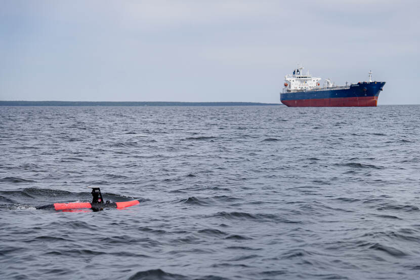Scout drone with ship in the background