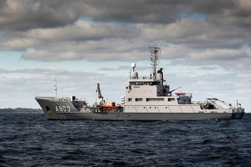 HNLMS Luymes sailing under dark clouds.