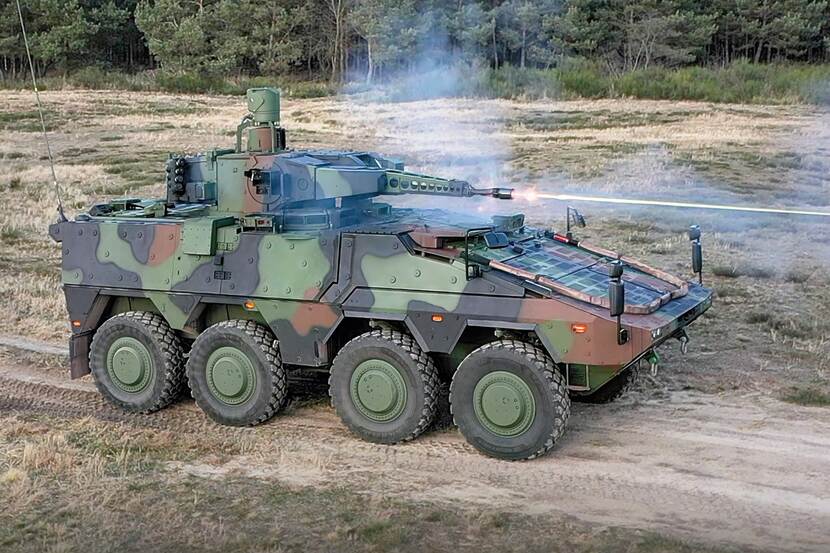 A Boxer Schakal driving and firing on a sandy road