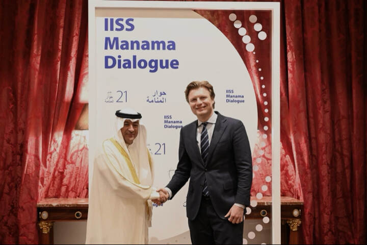 Brekelmans shakes hands with an Arabian man.