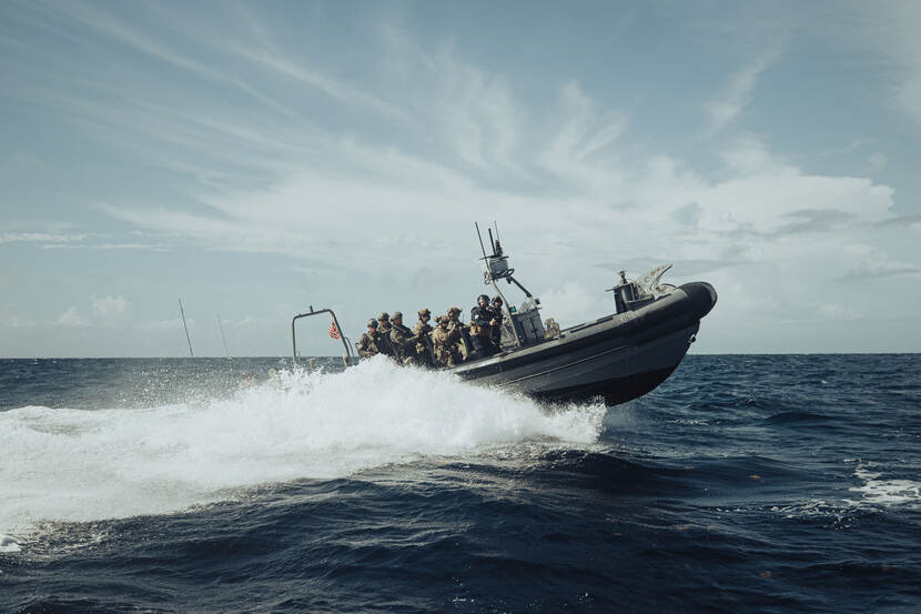 A RHIB (rigid hull inflatable boat) with a boarding team.