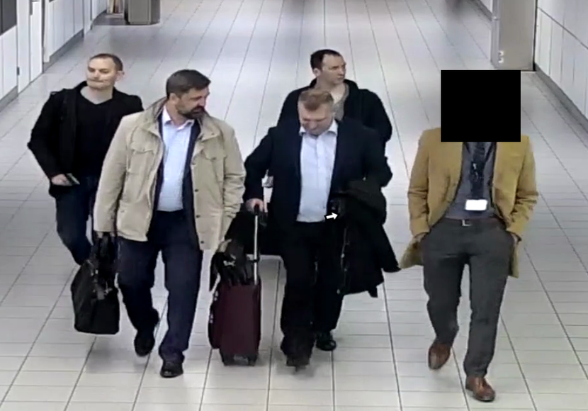 5 men at Schiphol Airport.