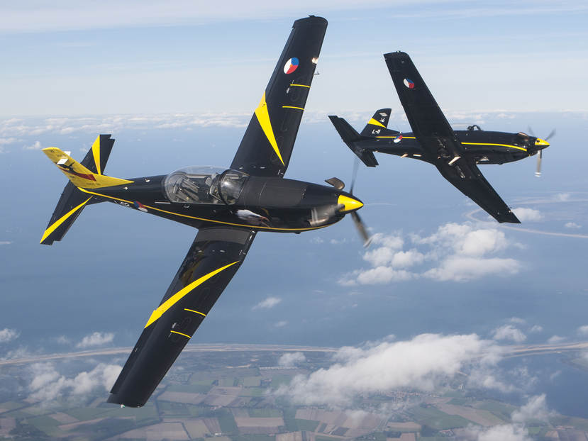 2 Pilatus PC-7 training aircraft perform a side by side roll.