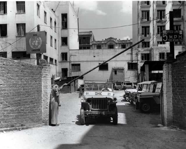 A Willy jeep passes the guard at the headquarters of UNSCOB in Thessaloniki.