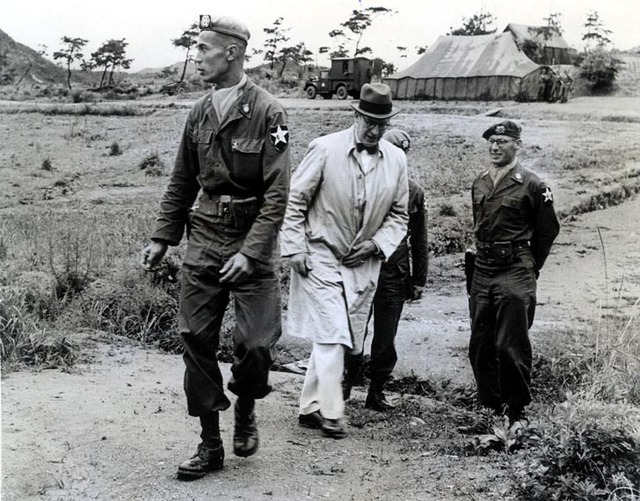 Battalion Commander Lieutenant Colonel Cornelis Knulst escorts Ferdinand Kranenburg, the State Secretary for War, during his 2nd visit to the Dutch unit.