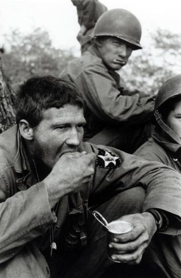 The Netherlands United Nations Detachment was deployed to Marathon Valley in May 1951. Soldiers eat hungrily after the march on Hill 975. Note the emblem of the 2nd India Head Division on the left sleeve.