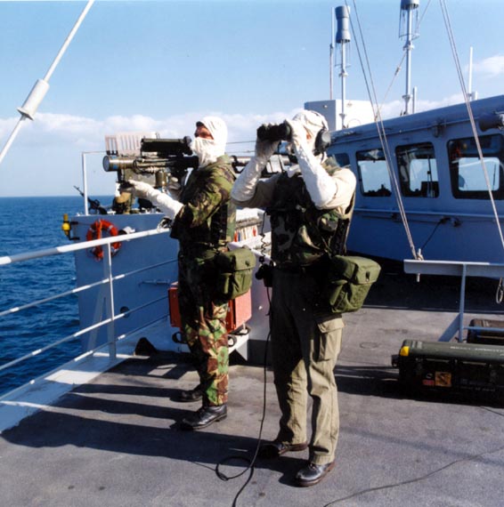 Marines monitor the airspace over the Persian Gulf from the deck of HNLMS Zuiderkruis, with a Stinger surface-to-air missile on stand-by, February 1991.