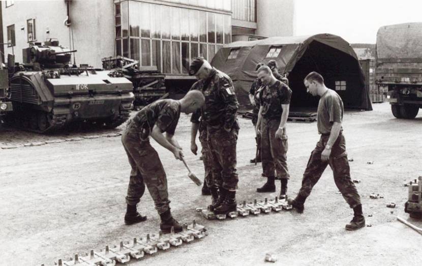 Brigadier General H.F. Coopmans lends a helping hand during a visit to C team in Knesovo, late April 1994.