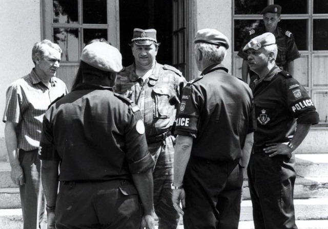 The Commander of the Royal Netherlands Marechaussee, Major General D.G.J. Fabius (right, back to the camera), meets a local Bosnian Serb police chief during a visit to UNIPTF in June 1996. On the left, with his back to the camera, Lieutenant Colonel R.C. Dongor.