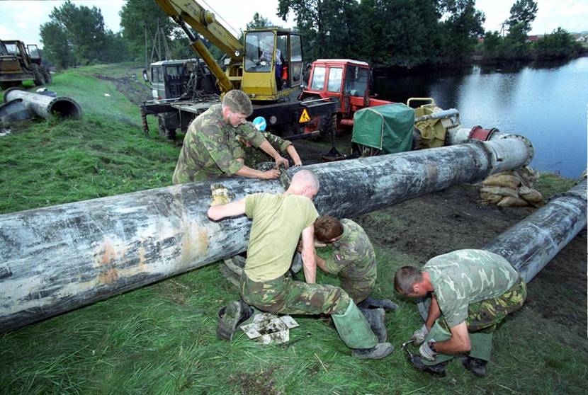 Royal Netherlands Army personnel not only transported equipment, but also rolled their sleeves up to connect the drainage pipes.