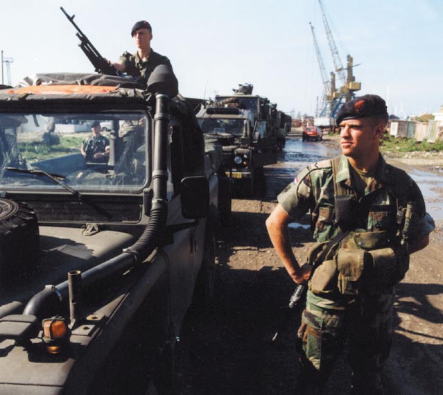 A convoy in Durrës ready for departure to Korcë in May 1999. The marines provide security for the Royal Netherlands Army trucks.