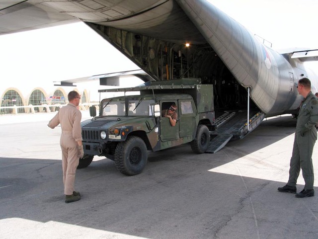 A US all-terrain vehicle, a Hummer, being driven on to a Dutch Hercules transport aircraft at Kandahar airfield in Afghanistan.