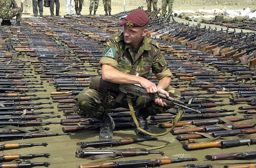 Corporal I. Pater in the midst of over 1,200 firearms handed in between 27 and 30 August 2001.