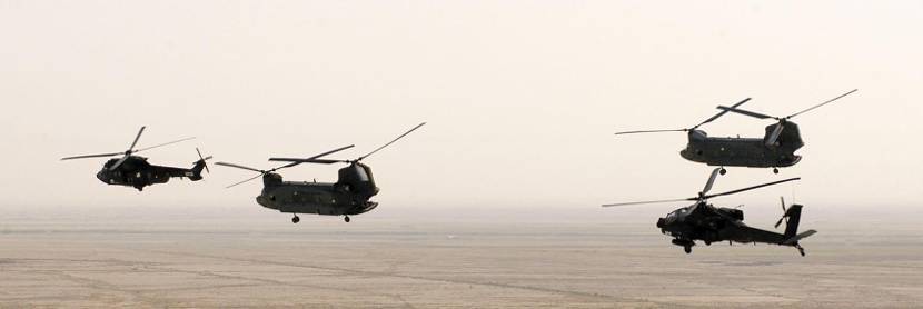 2 Chinooks, a Cougar and an Apache in flight near Talil Air Base over the desert in southern Iraq, early August 2004.