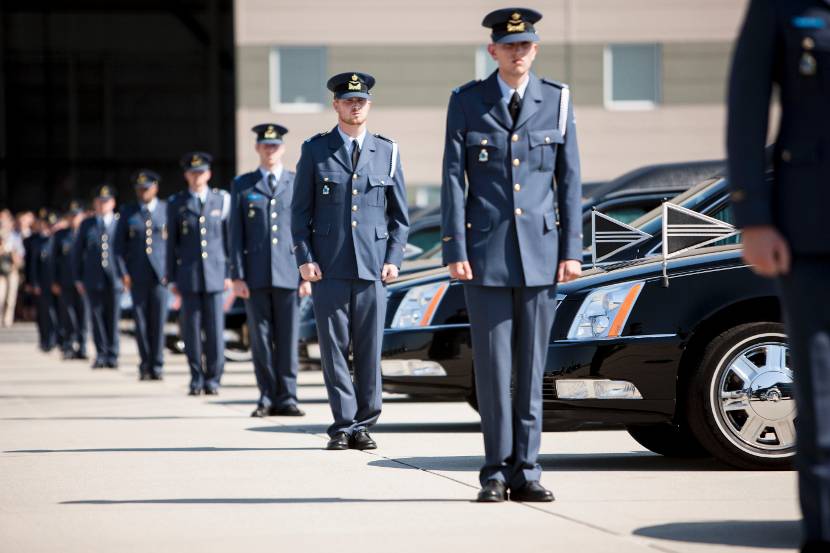 Royal Netherlands Air Force personnel lined up next to hearses at Eindhoven Air Base during the return of bodies of victims of the MH17 disaster.