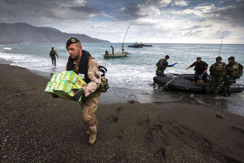 Emergency aid goods being brought on land from RHIBs.